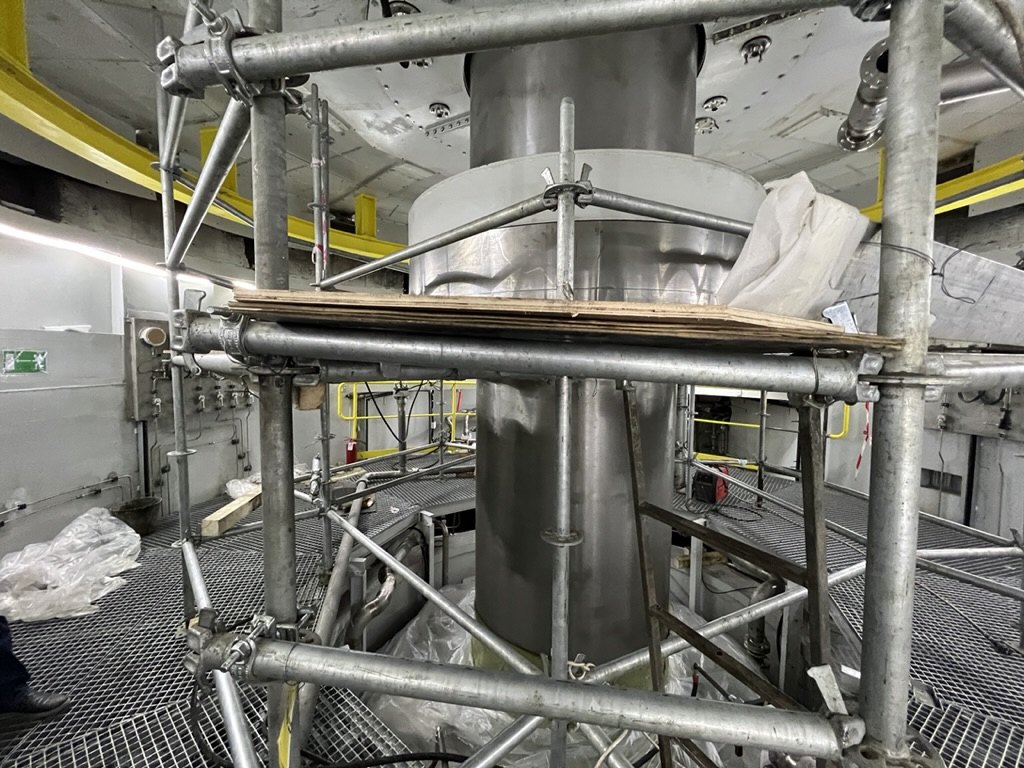 A generator shaft surrounded by scaffolding during rehabilitation