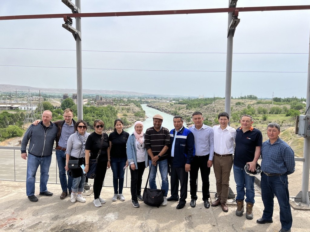 The Uch-Kurgan project implementation team on the dam, with the Naryn river behind